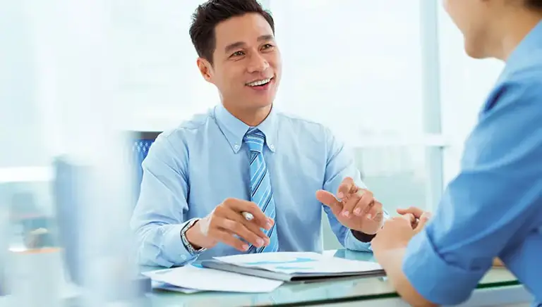 Two men in an office setting are in conversation